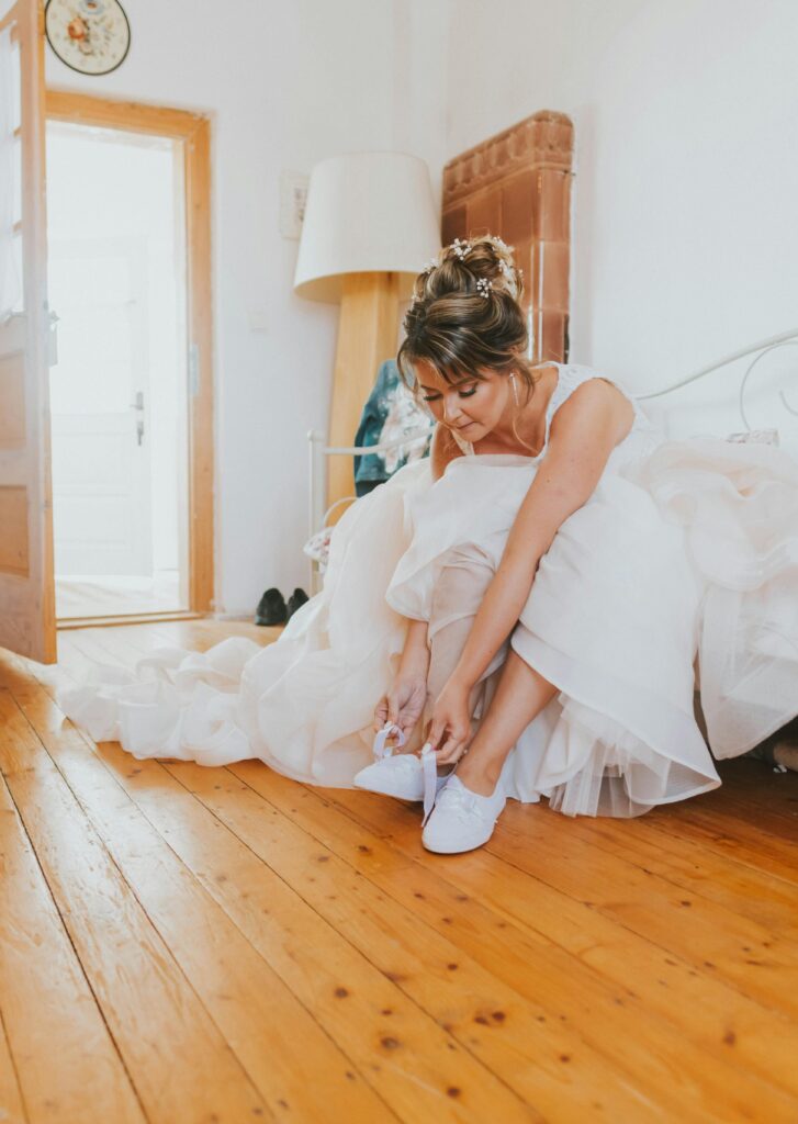 A serene bride getting ready with her bridesmaids in a softly lit room, symbolizing a stress-free wedding morning.